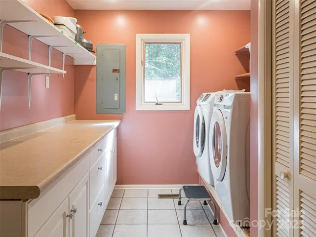 a bed sitting in a spacious bedroom next to a window
