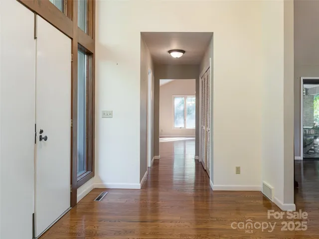 a view of a hallway with wooden floor
