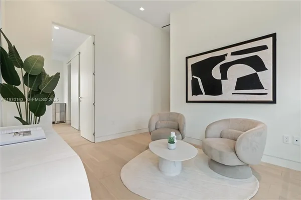 a living room with furniture and a potted plant