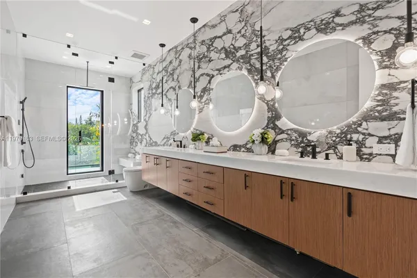 a spacious bathroom with a double vanity sink and a mirror