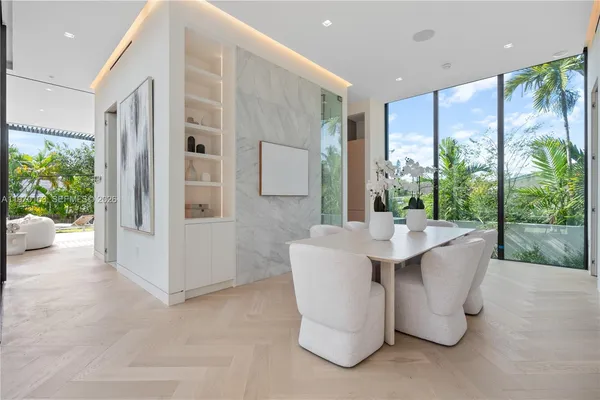 a living room with large windows and furniture