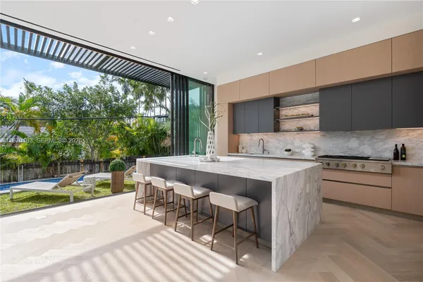 a kitchen with a sink and a stove top oven