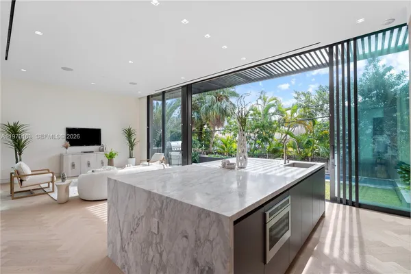 a living room with kitchen island furniture and a flat screen tv