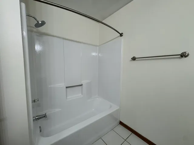 a bathroom with a shower and a glass door