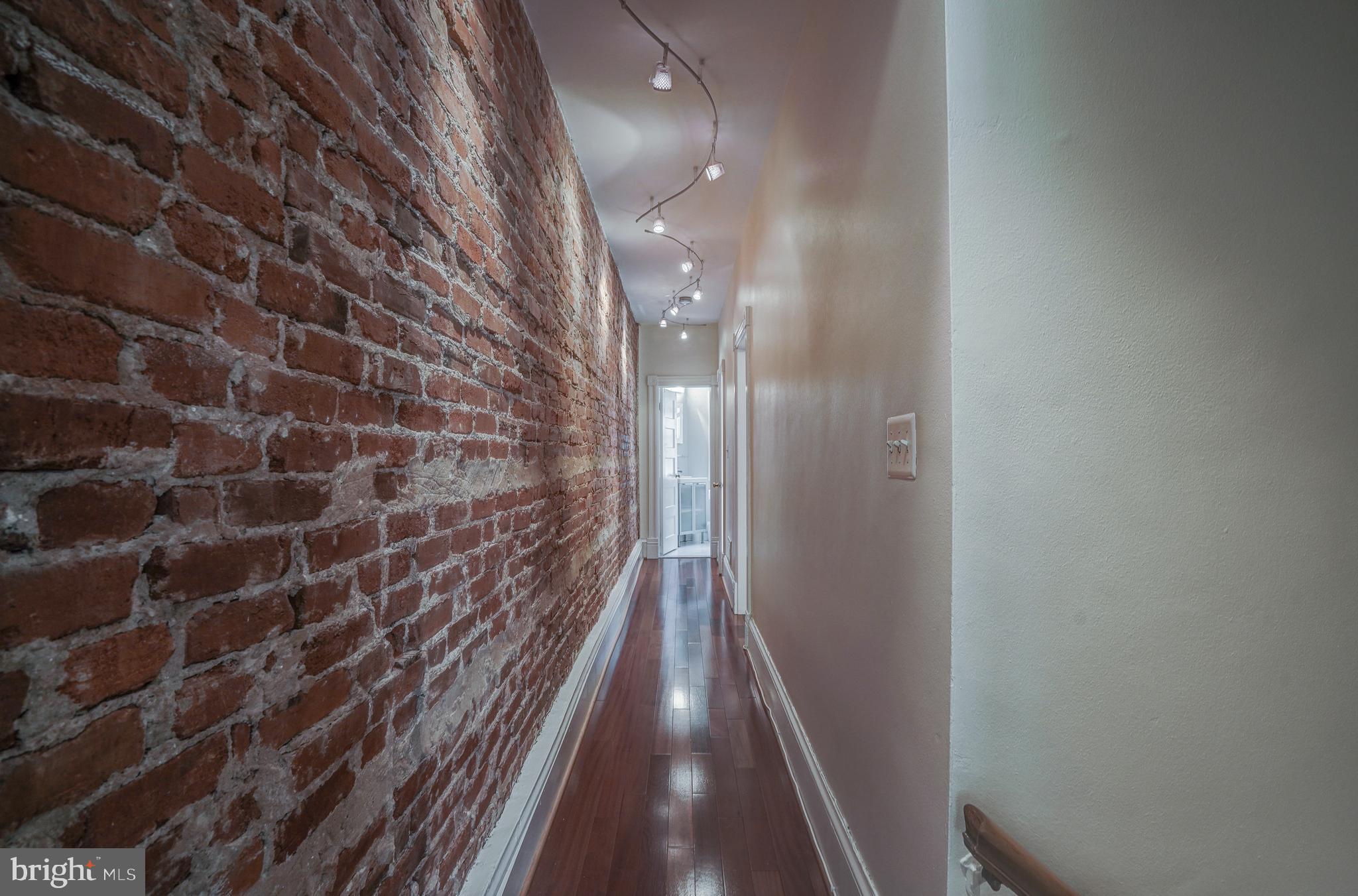 1025 30th Street Northwest Washington, DC 20007 - Photo 11 of 35 exposed brick hallway