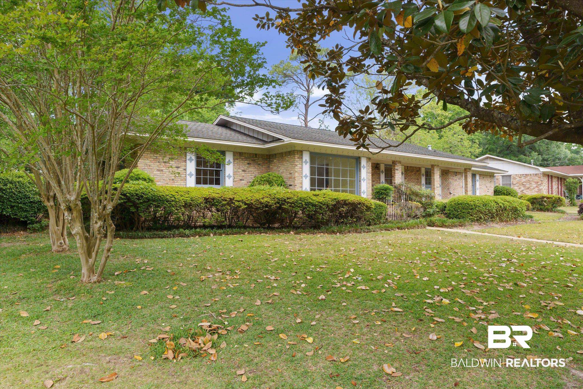 1182 Ginger Drive Mobile, AL 36693 - Photo 35 of 37 Brick exterior featuring a gabled roofline and an expansive front lawn