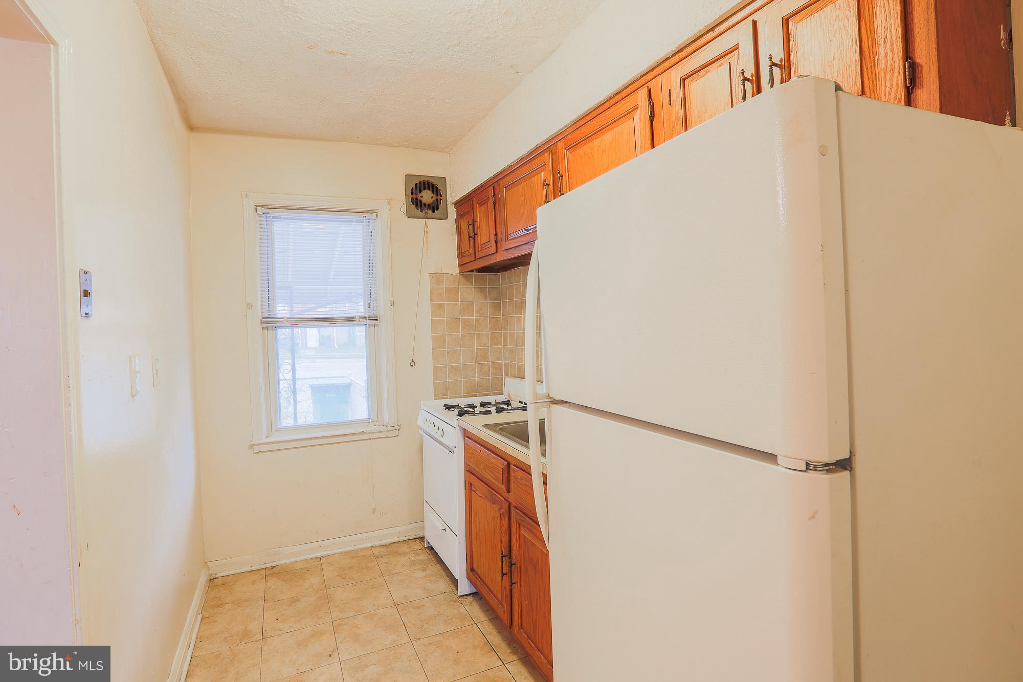 1046 Tunbridge Road Baltimore, MD 21212 - Photo 14 of 30 a view of a kitchen with a sink and refrigerator