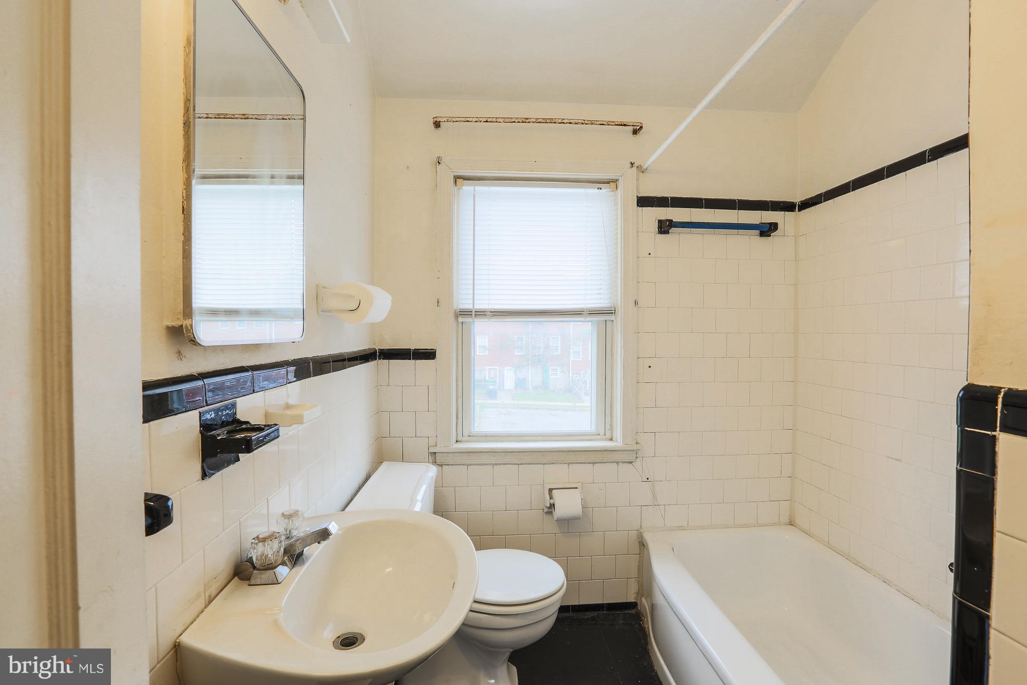 1046 Tunbridge Road Baltimore, MD 21212 - Photo 23 of 30 a bathroom with a sink a toilet and shower