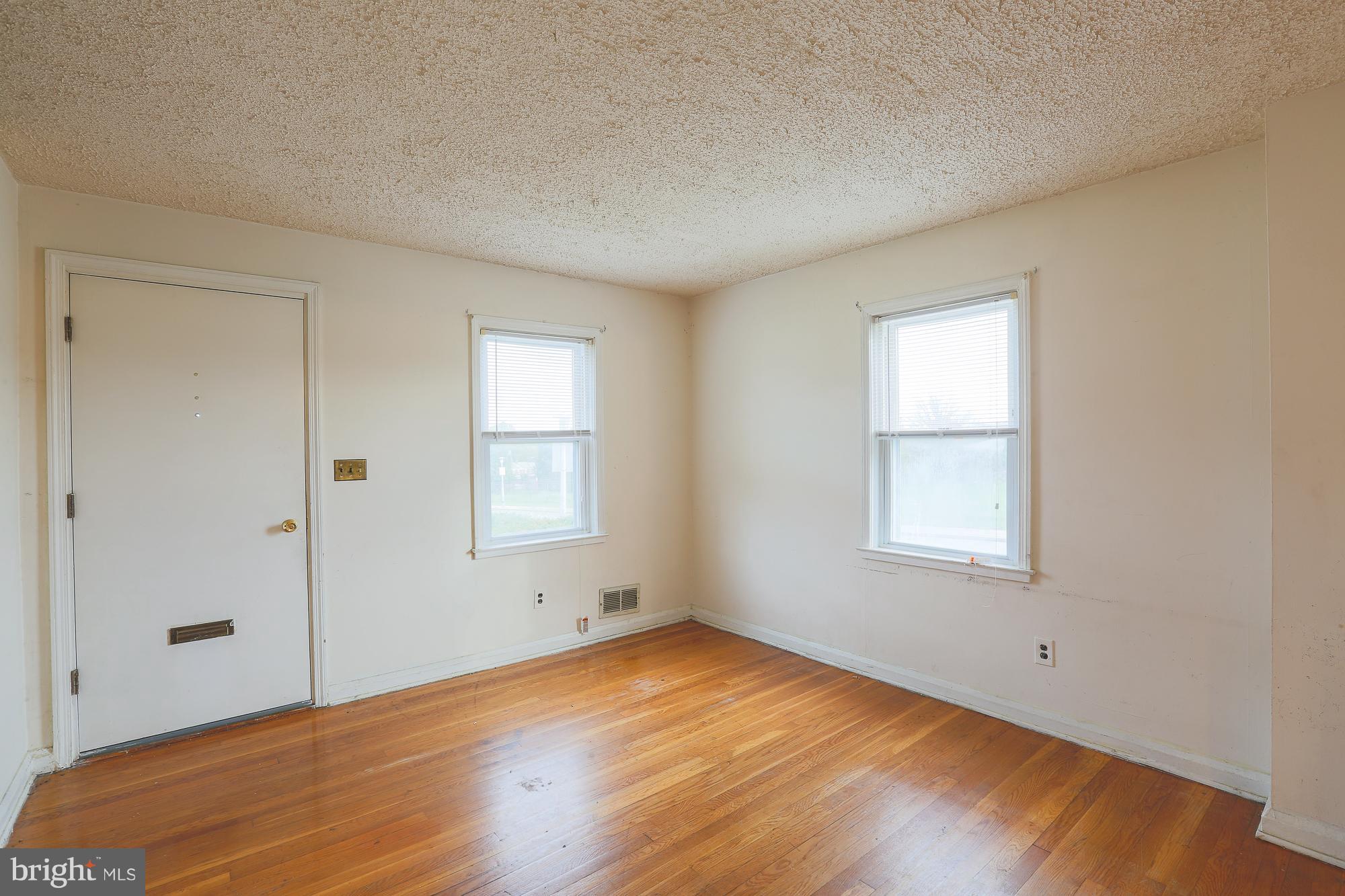 1046 Tunbridge Road Baltimore, MD 21212 - Photo 5 of 30 an empty room with wooden floor and windows