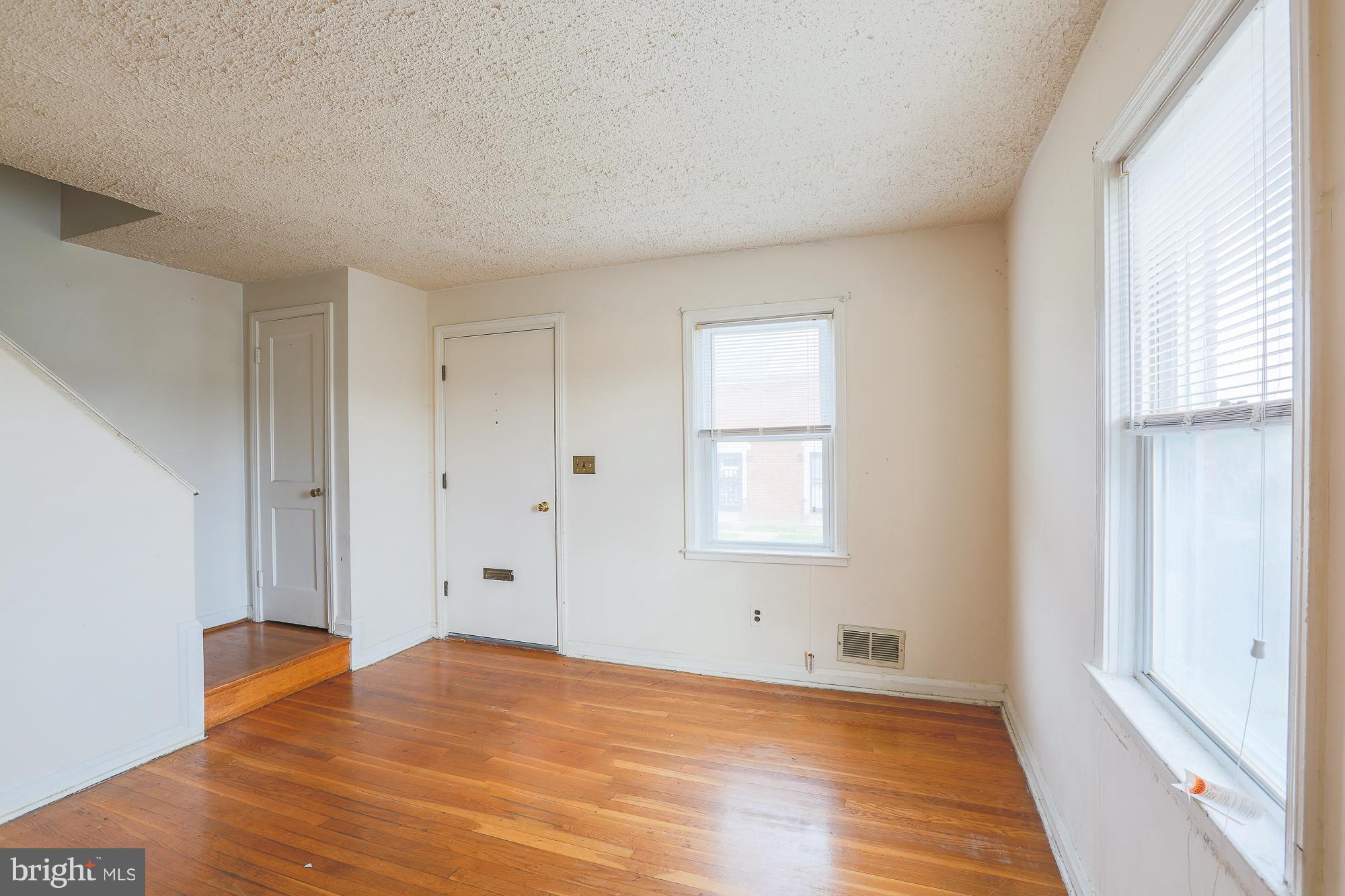 1046 Tunbridge Road Baltimore, MD 21212 - Photo 6 of 30 a view of empty room with wooden floor and fan