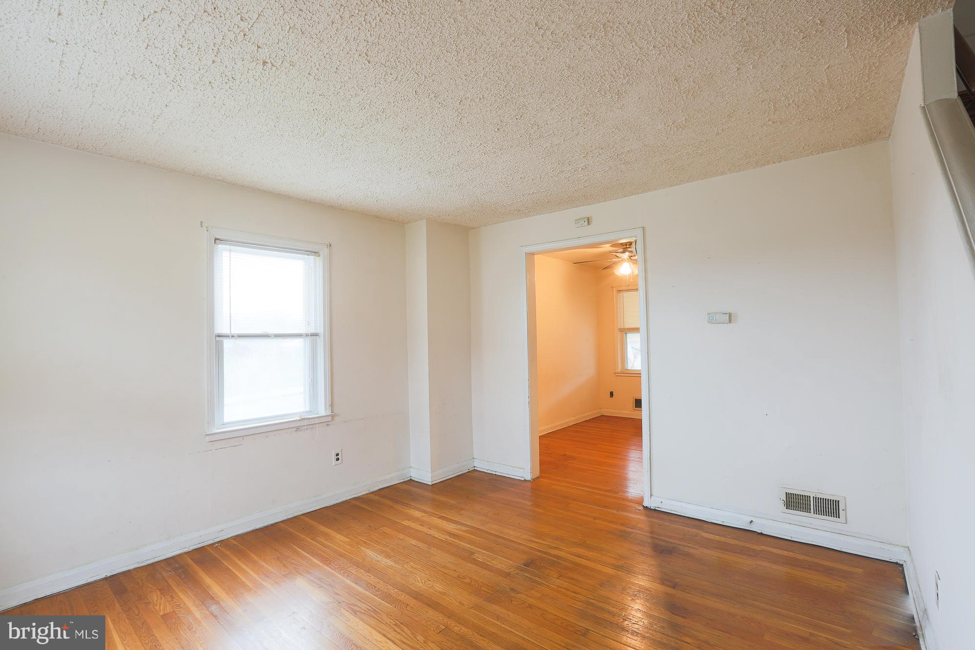 1046 Tunbridge Road Baltimore, MD 21212 - Photo 8 of 30 an empty room with wooden floor and windows