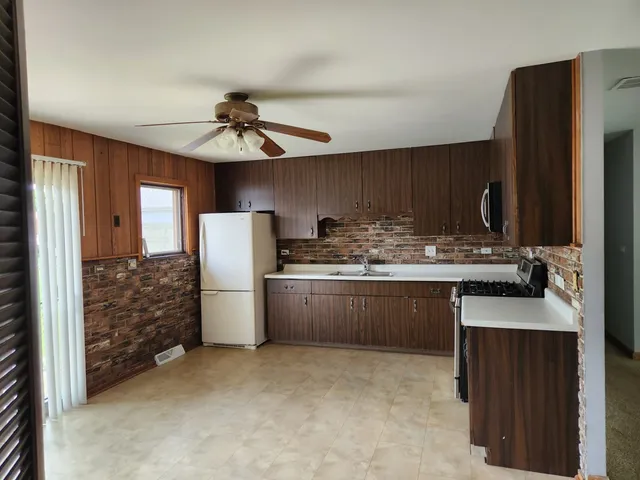 a kitchen with a refrigerator and a sink