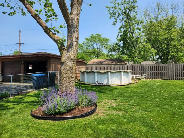 a front view of house with a garden