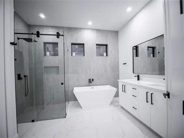 a bathroom with a double vanity sink mirror and shower