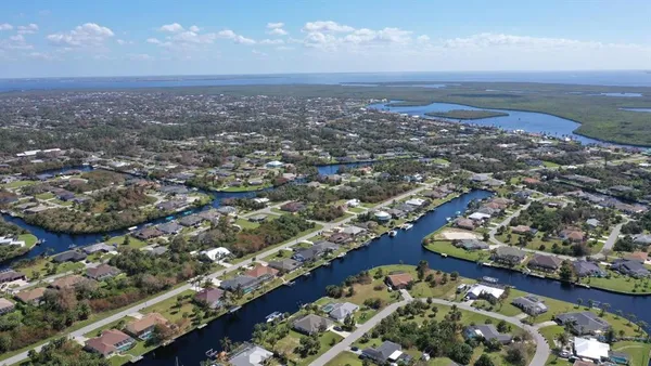 an aerial view of residential building and lake