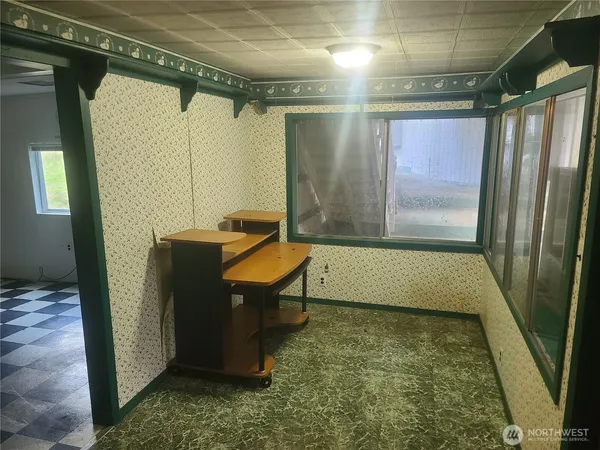 a view of a room with a wooden door