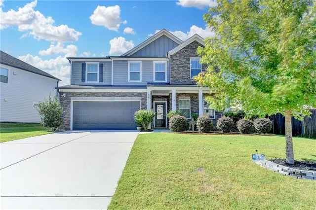a front view of a house with garden