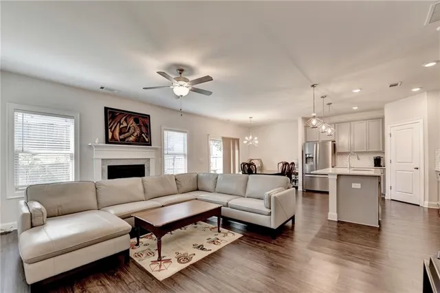 a living room with furniture fireplace and a window