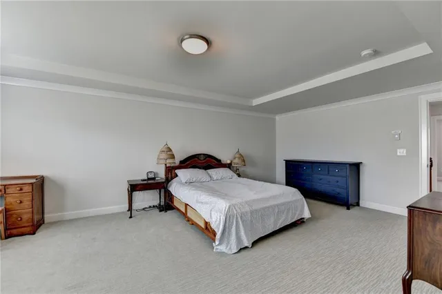 a spacious bedroom with a bed and a table