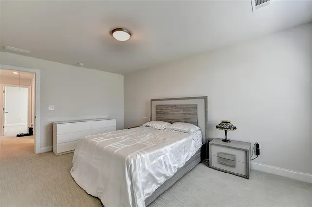 a bedroom with a bed and a lamp