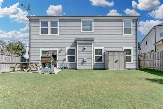 a view of a house with yard and sitting area