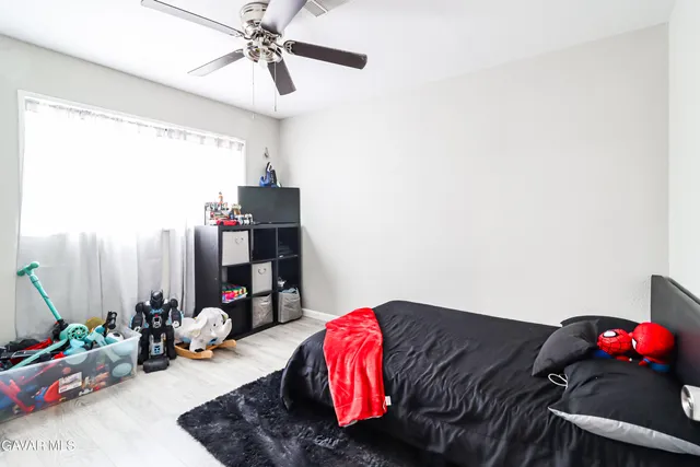 a bedroom with bed and a chandelier