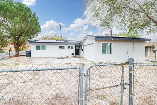 a view of a house with snow on a road