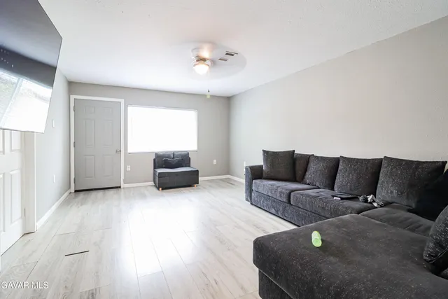 a living room with furniture and a large mirror