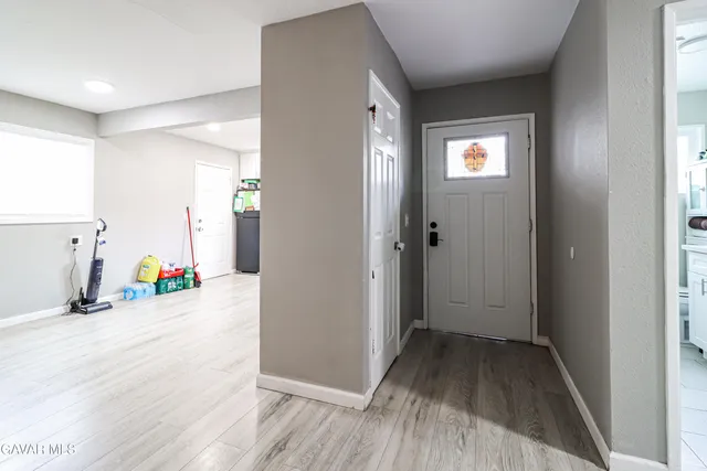 a view of a livingroom with wooden floor and door
