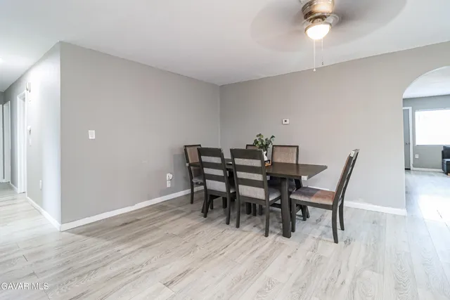 a dining room with furniture and wooden floor