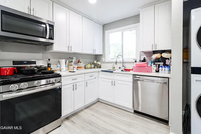 a kitchen with a sink stove and microwave