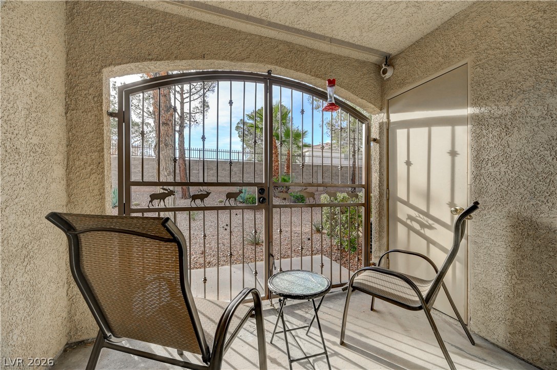 7885 West Flamingo Road, Unit 1071 Las Vegas, NV 89147 - Photo 26 of 28 Relax on this shaded patio featuring a decorative security gate and private entrance.
