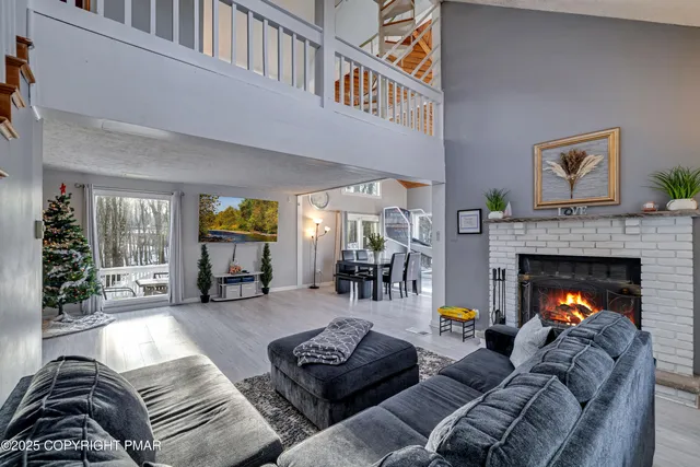 a view of a hallway with wooden floor and windows