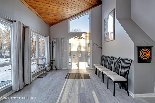 a living room with a fireplace and a potted plant