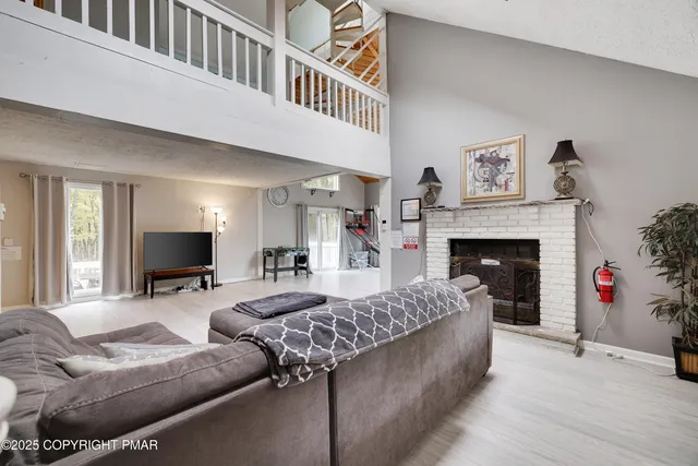 a kitchen with white cabinets and black appliances