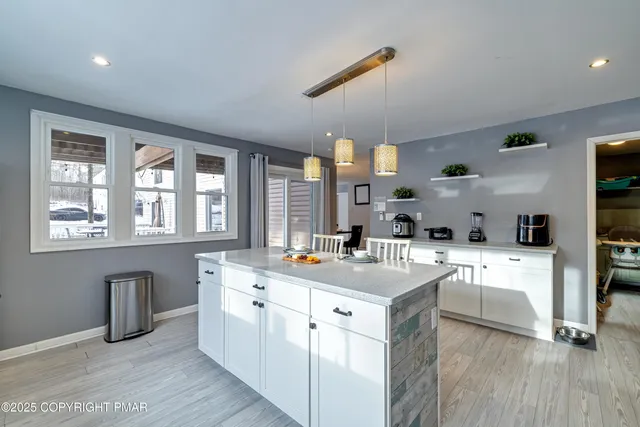 a living room with furniture a flat screen tv and a bookshelf