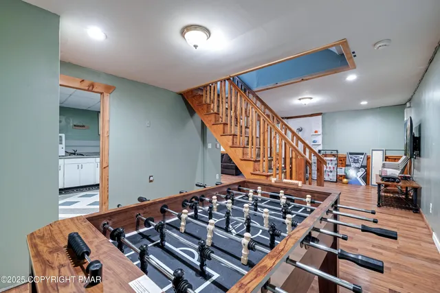 a bedroom with a bed and dresser with mirror