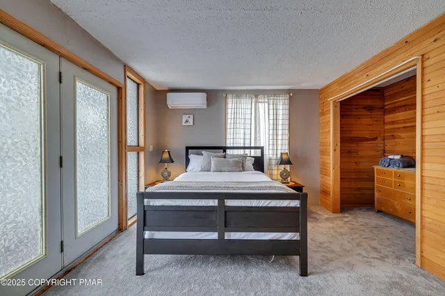 a bedroom with a bed and a potted plant