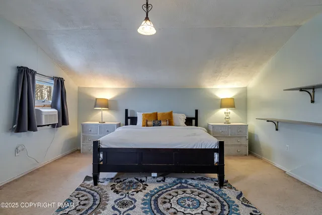 a large bedroom with a bed and a fireplace