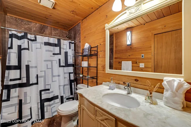 a view of a two chairs with wooden floor and fence
