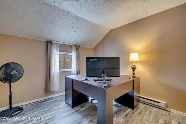 an aerial view of a swimming pool with outdoor seating