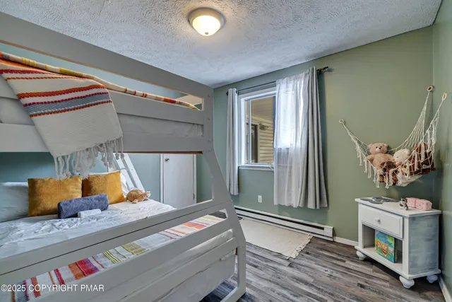 a view of a patio with table and chairs with wooden floor and fence