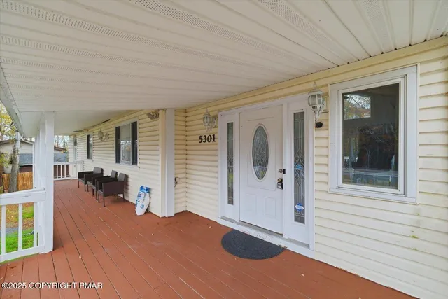 a view of a livingroom with furniture and a porch