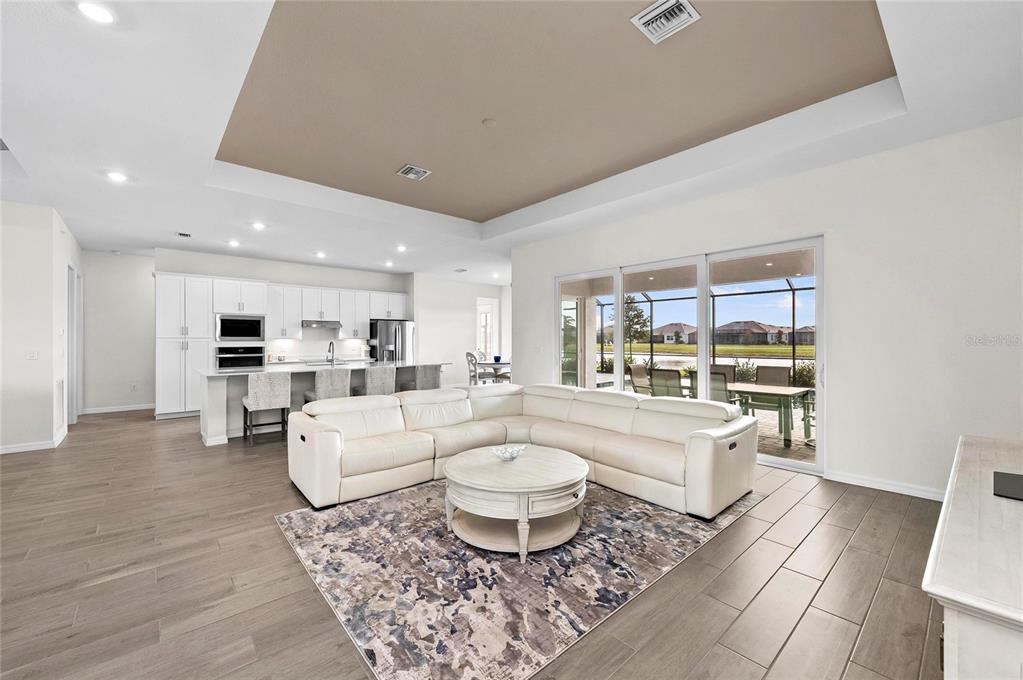 17341 Sandpearl Road Venice, FL 34293 - Photo 11 of 95 a living room with furniture a table and a large window