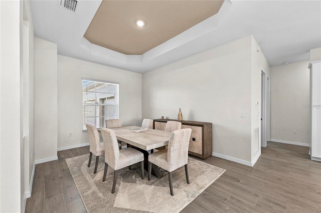 17341 Sandpearl Road Venice, FL 34293 - Photo 14 of 95 a view of a dining room with furniture and wooden floor