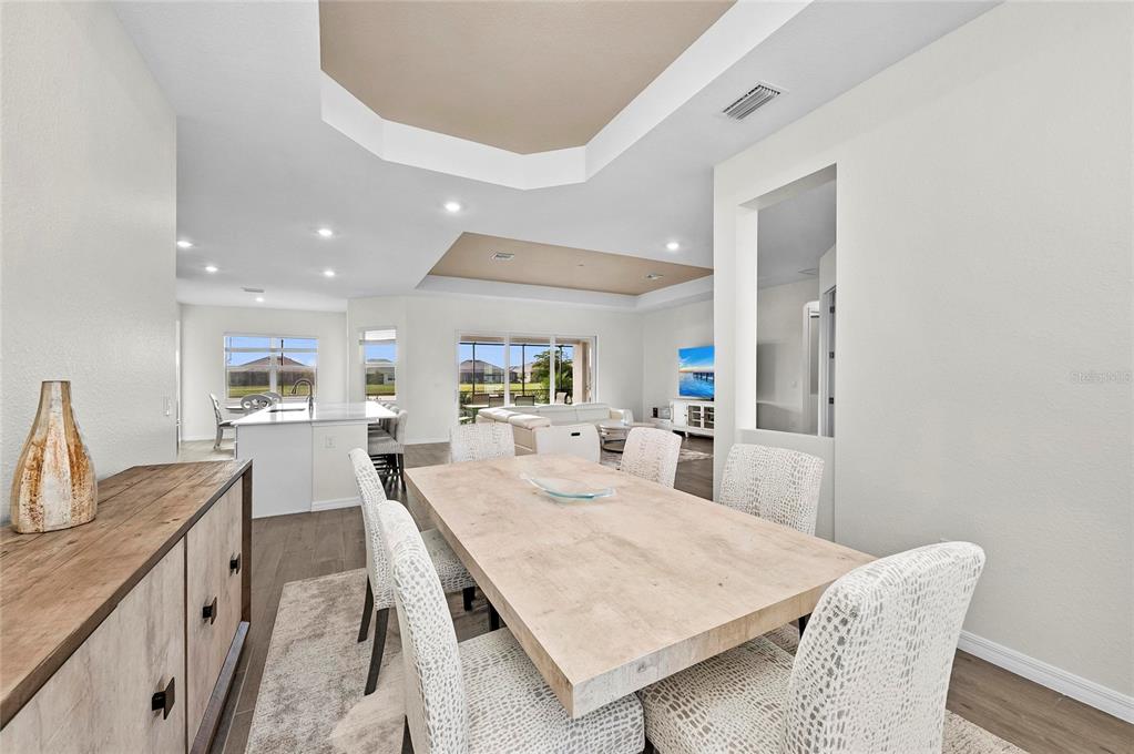 17341 Sandpearl Road Venice, FL 34293 - Photo 15 of 95 a dining room with furniture and wooden floor