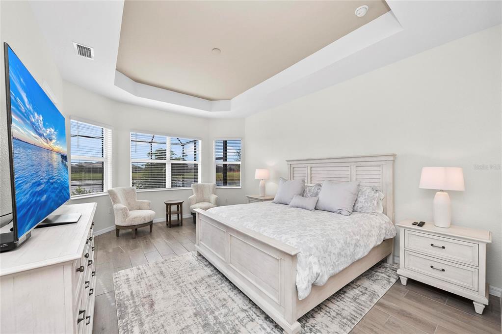 17341 Sandpearl Road Venice, FL 34293 - Photo 24 of 95 a bedroom with a bed and a couch