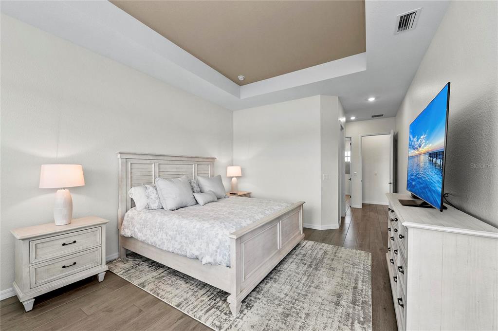 17341 Sandpearl Road Venice, FL 34293 - Photo 27 of 95 a bedroom with a bed and a night stand