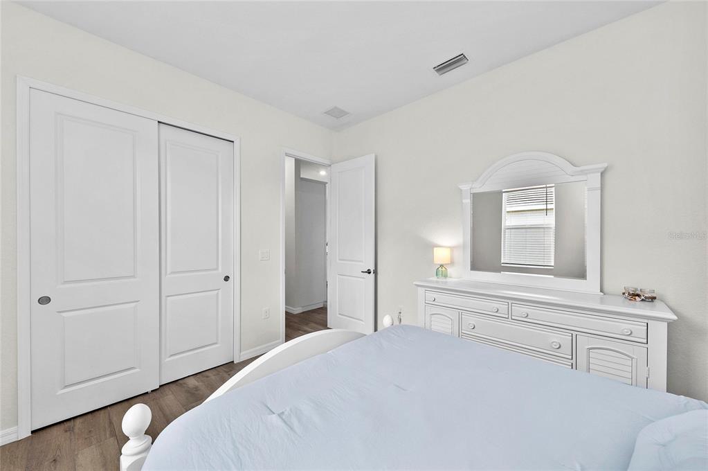 17341 Sandpearl Road Venice, FL 34293 - Photo 39 of 95 a bedroom with a bed and a television