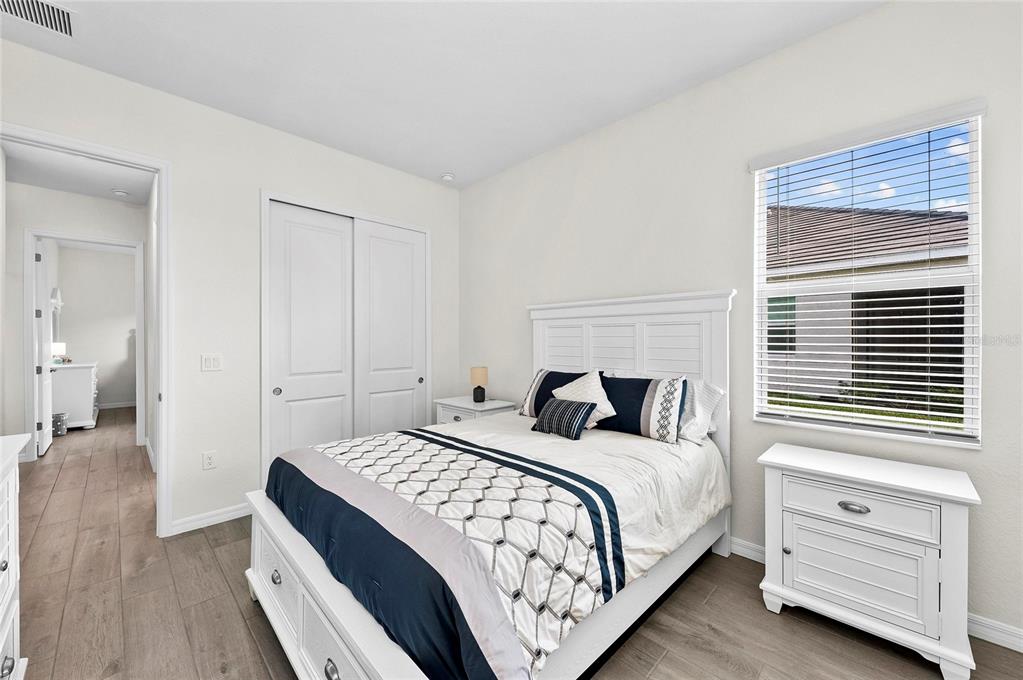 17341 Sandpearl Road Venice, FL 34293 - Photo 43 of 95 a bedroom with a bed and a table